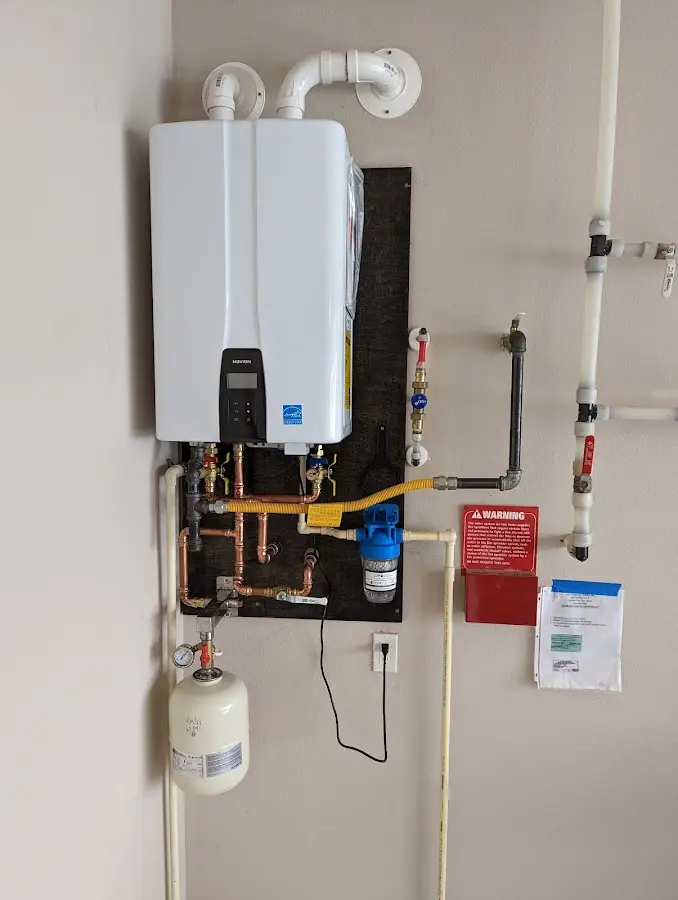 Professional plumber installing copper piping in a Oaklyn home